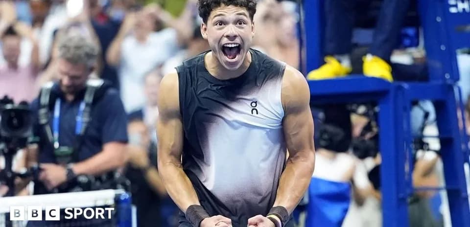 Tennis player celebrating victory with raised fists