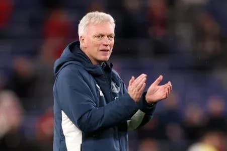 Manager applauding during a match on the sidelines