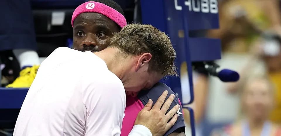Two players embracing during a tennis match