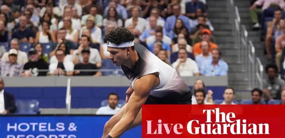 Tennis player serving during a match with spectators