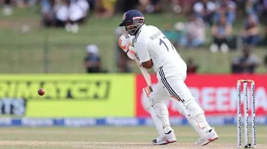 Batsman preparing to play a delivery in cricket match