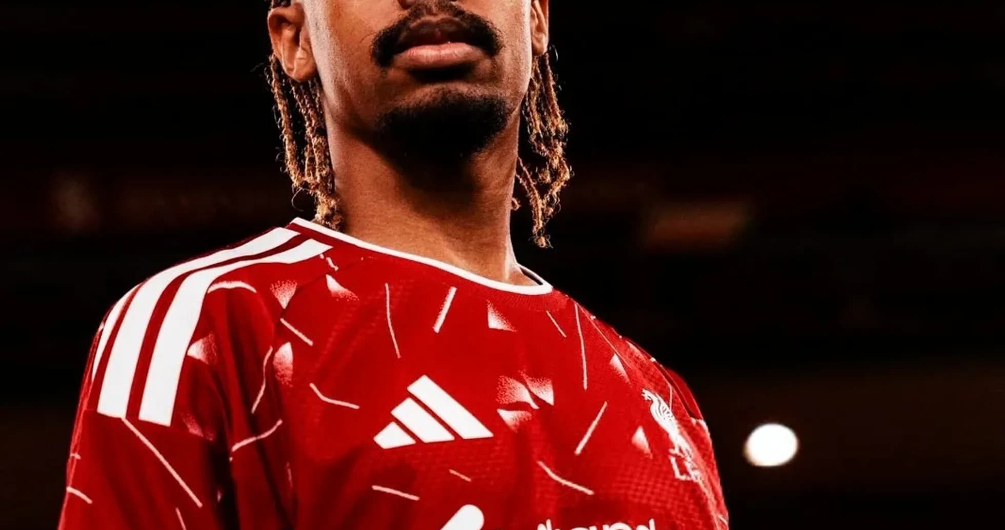 Player posing in Liverpool FC home jersey