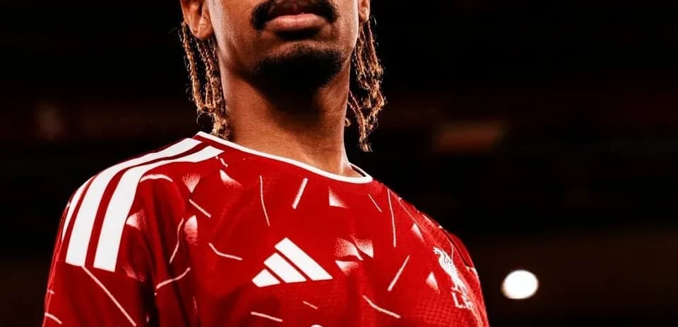 Player posing in Liverpool FC home jersey