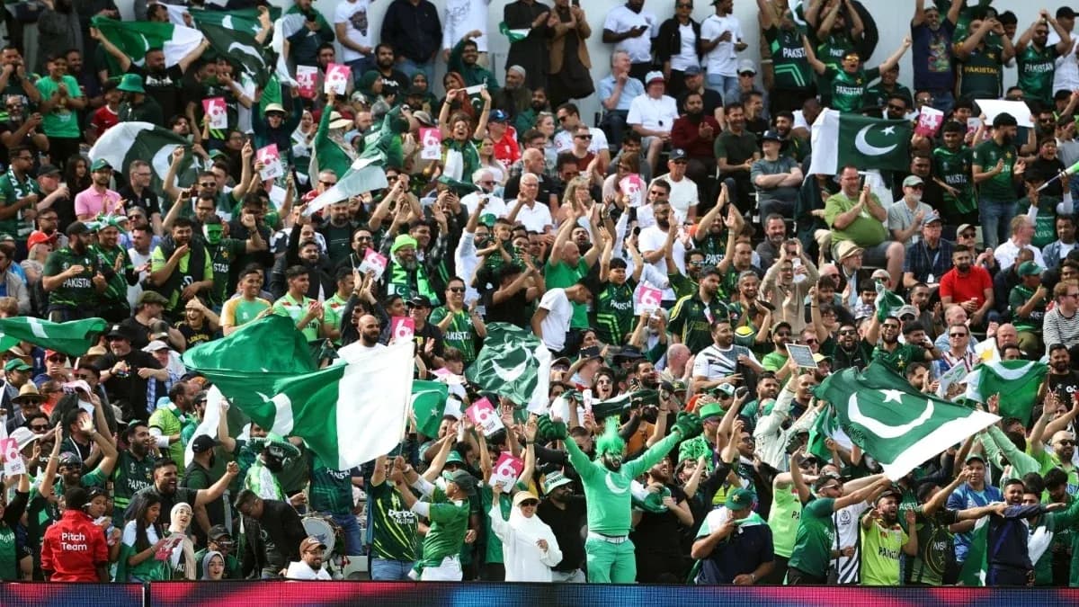 Fans cheering with flags during cricket match