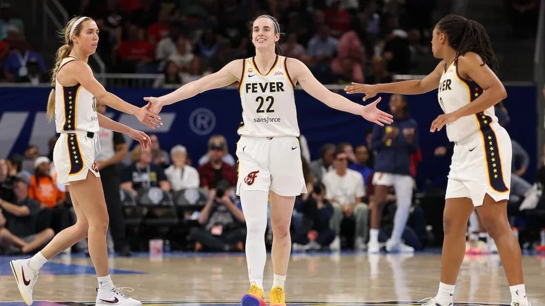 Three Indiana Fever players celebrating on court