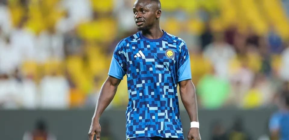 Player in blue patterned jersey during warm-up