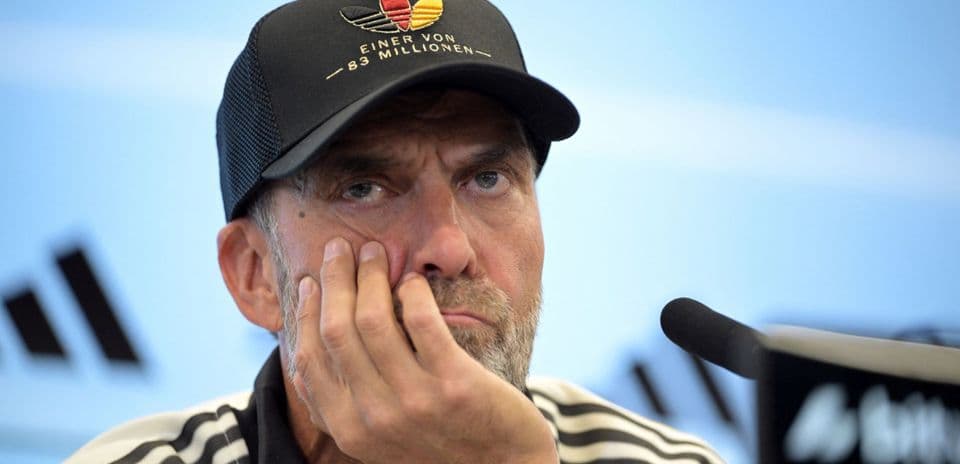 Manager at press conference with thoughtful expression