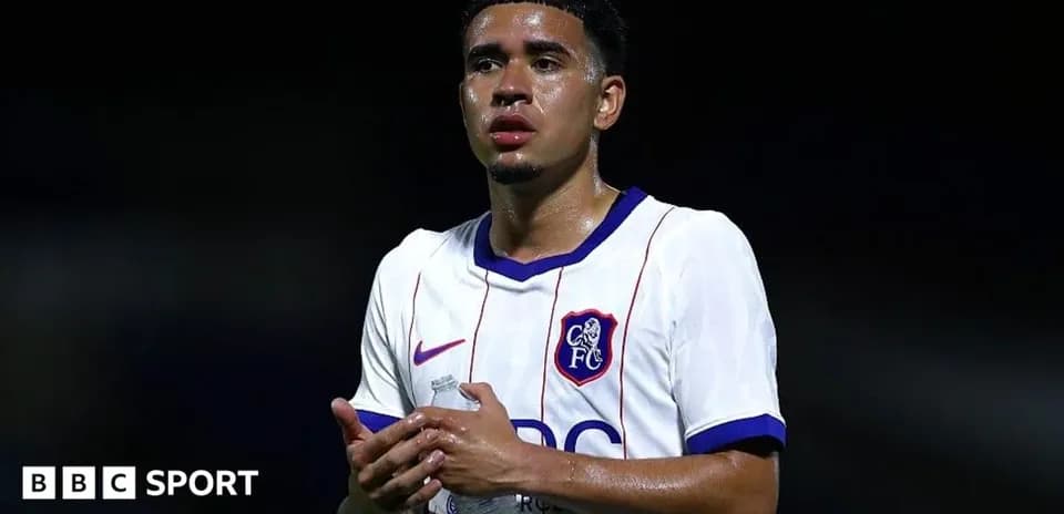Player in white jersey holding a water bottle