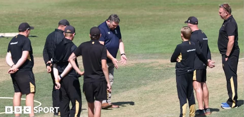 Coaches discussing strategies on cricket field