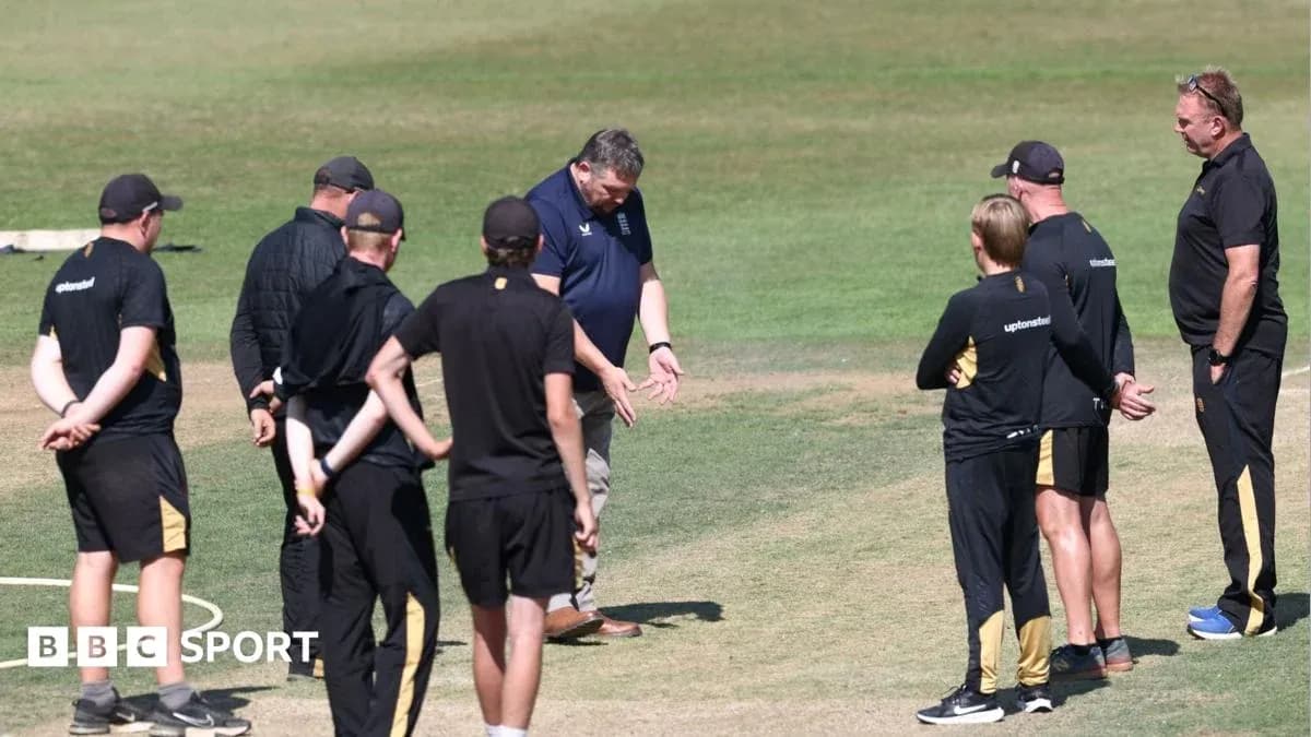 Coaches discussing strategies on cricket field Coaches discussing strategies on cricket field