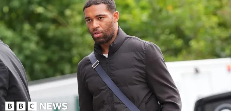 Player walking with a shoulder bag outdoors