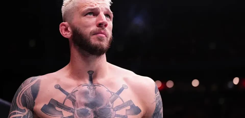 Bare-chested fighter with tattoos in ring