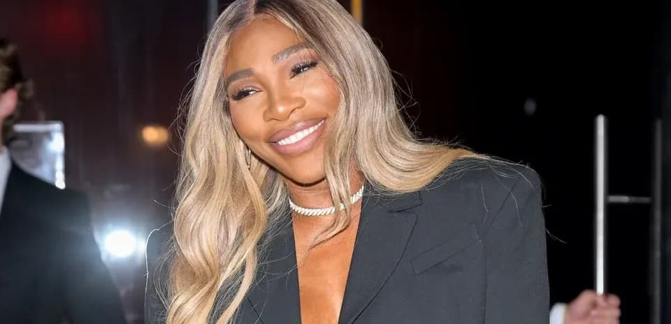 Person smiling in a black blazer outfit