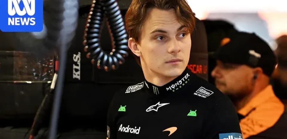 Driver in McLaren uniform in pit area