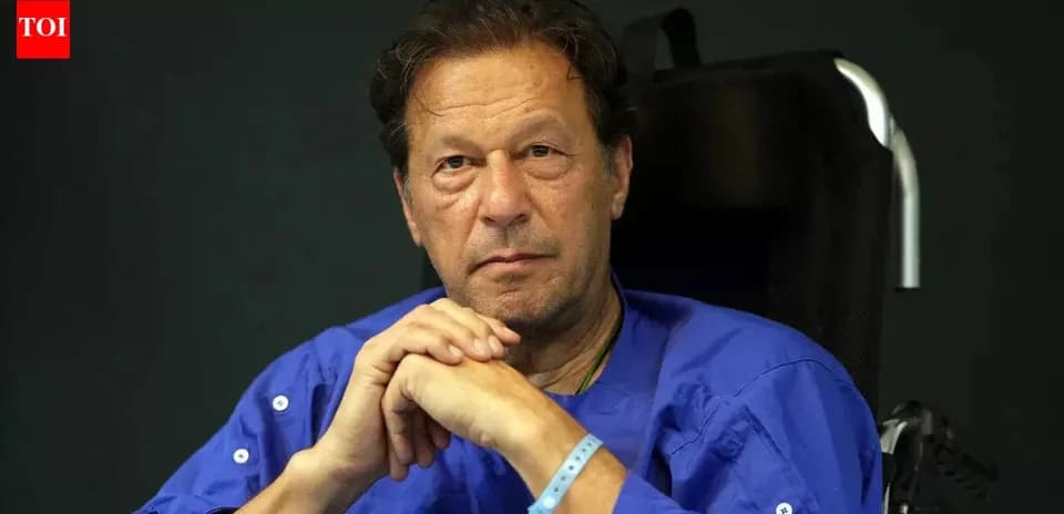Man in wheelchair wearing blue shirt with serious expression