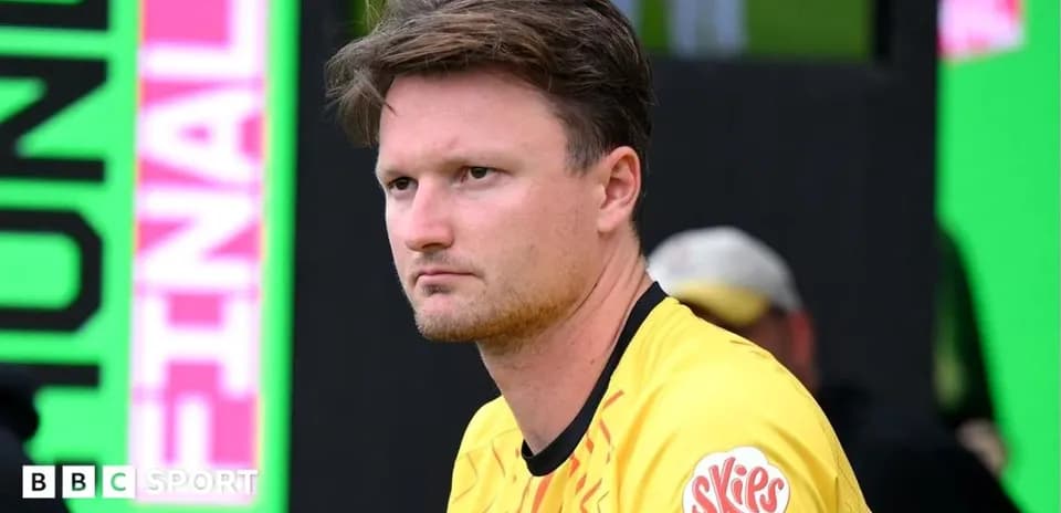 Player in yellow kit sitting on the sidelines