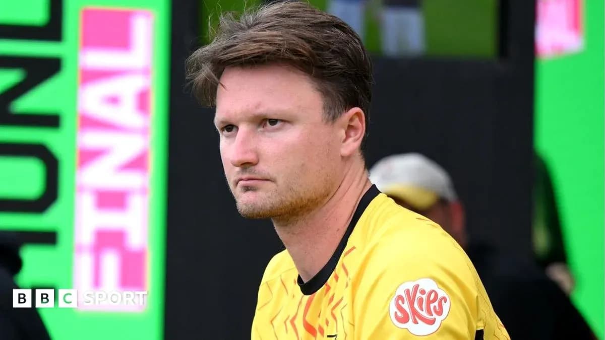 Player in yellow kit sitting on the sidelines