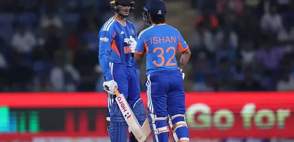 Two cricketers discussing strategy on the field