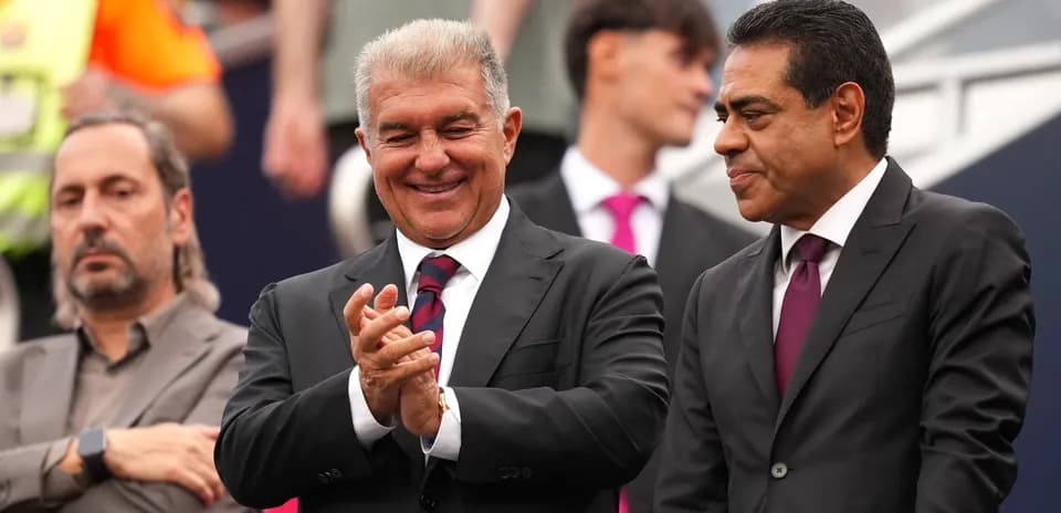 Three individuals in suits at a sporting event