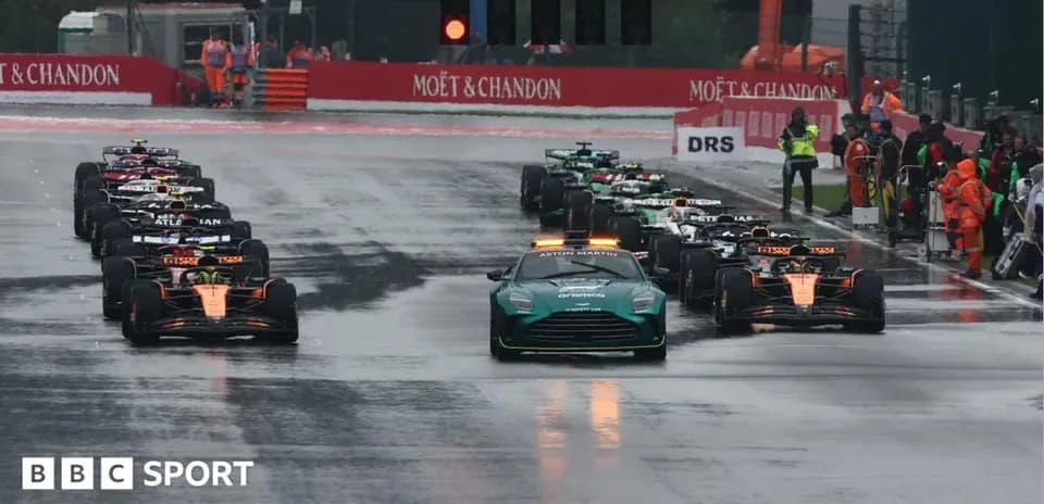 Cars lined up on wet track before Formula 1 race