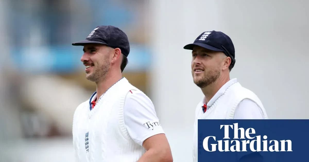 Two cricketers walking on the field in uniforms