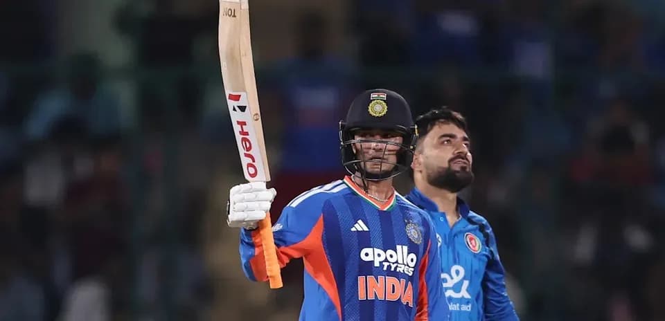 Batter celebrating with raised bat during match