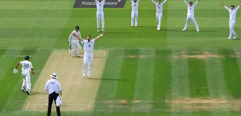 Bowler celebrating as batsman walks away from pitch