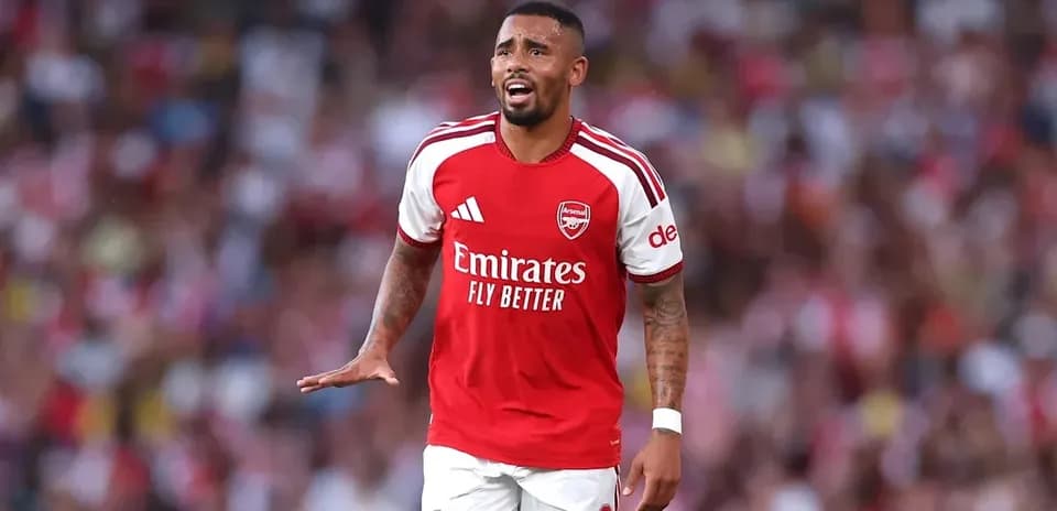 Arsenal player gesturing on the pitch during match
