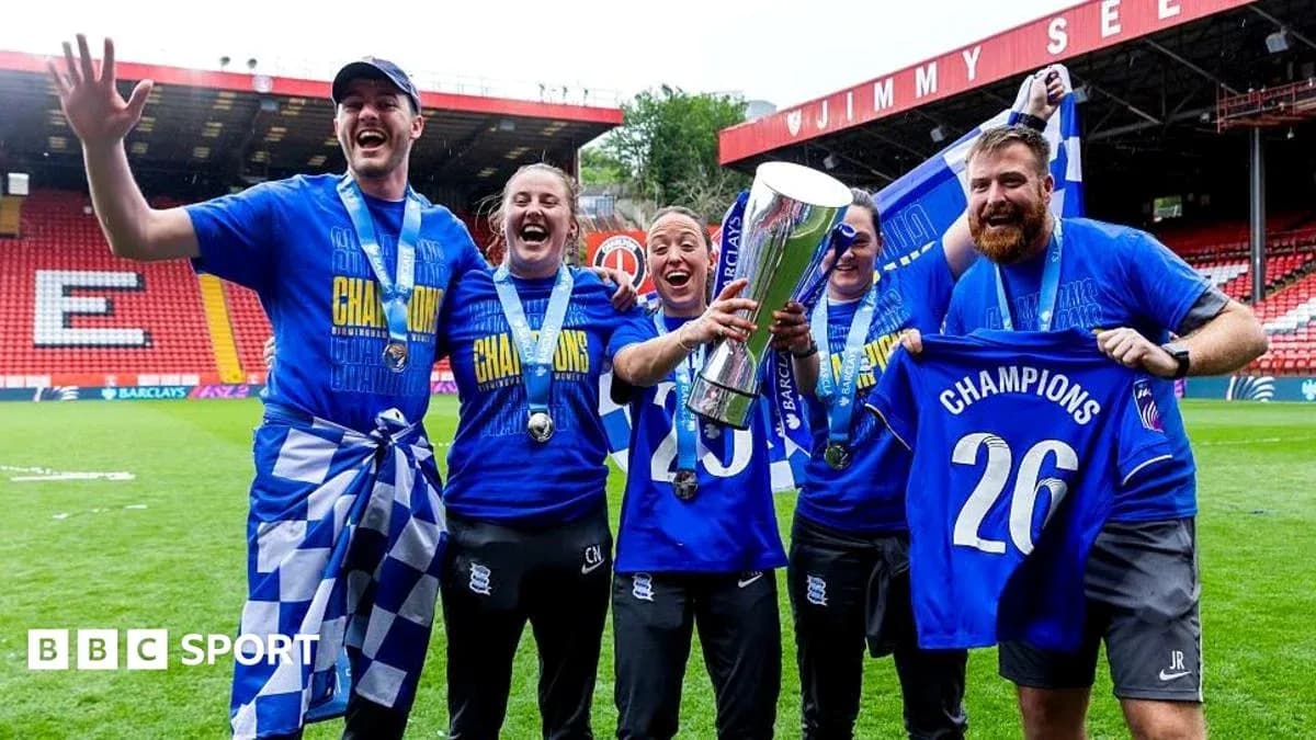 Team celebrating with trophy and champion shirts