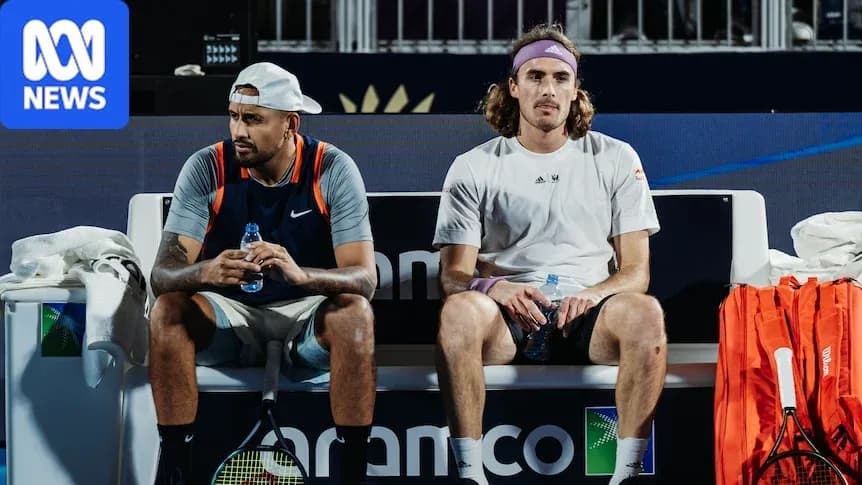 Two tennis players sitting on bench during match