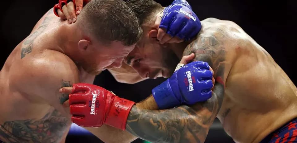 Two fighters clinching during a boxing match