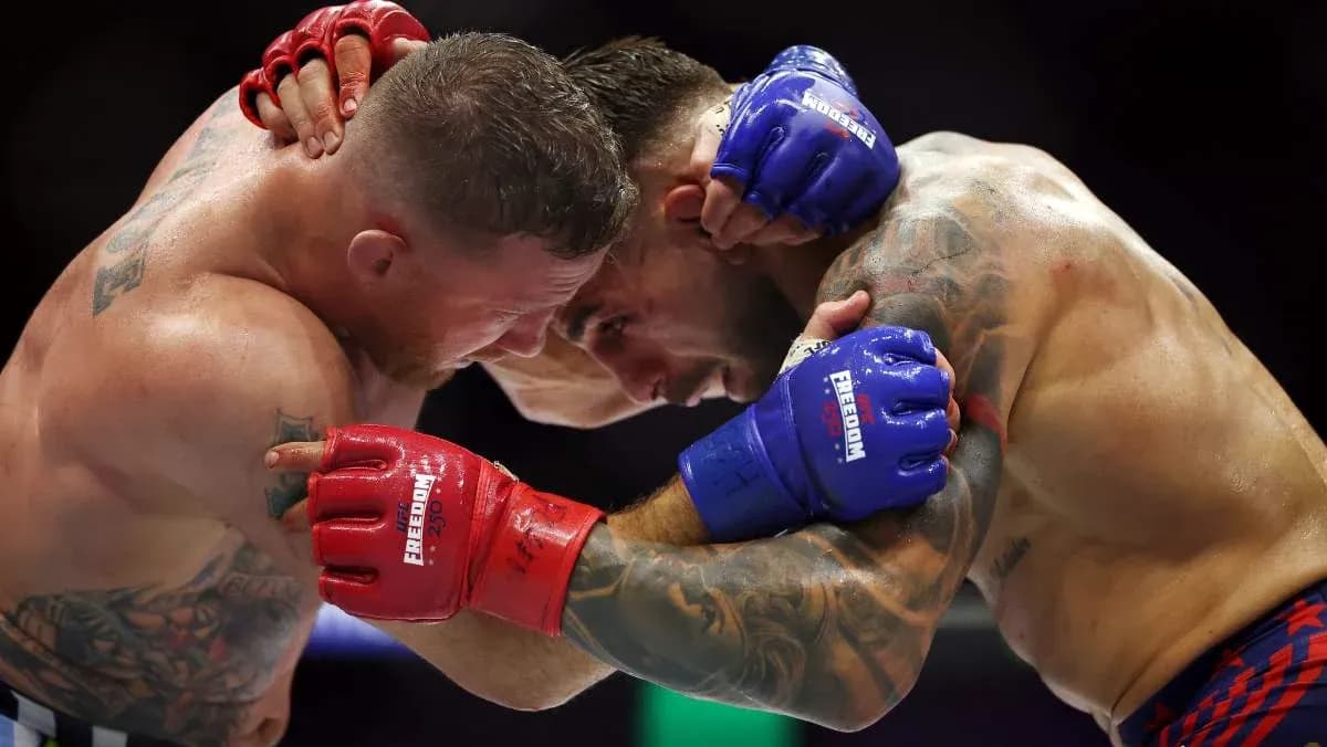 Two fighters clinching during a boxing match