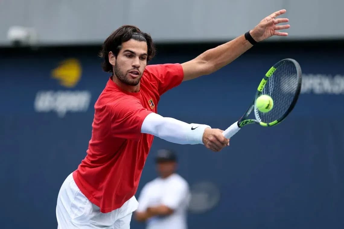 Tennis player hitting a forehand shot during practice