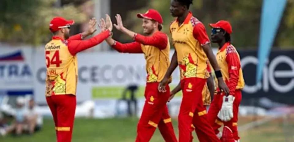 Cricket team celebrating a wicket on field