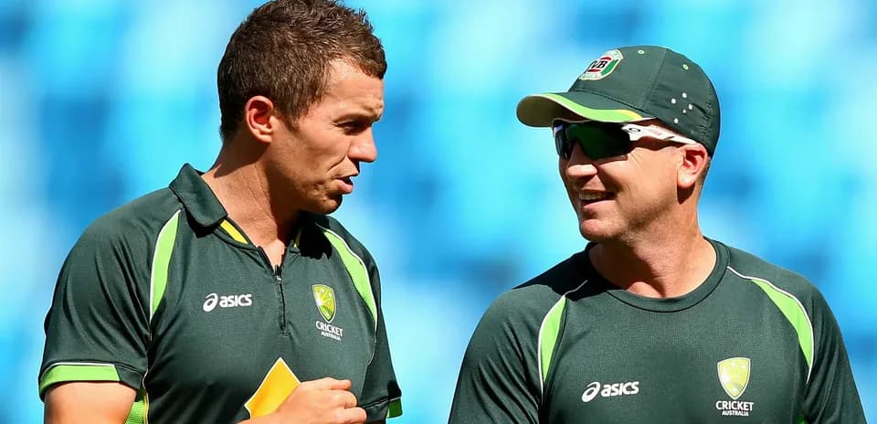 Two Australian cricketers conversing during practice