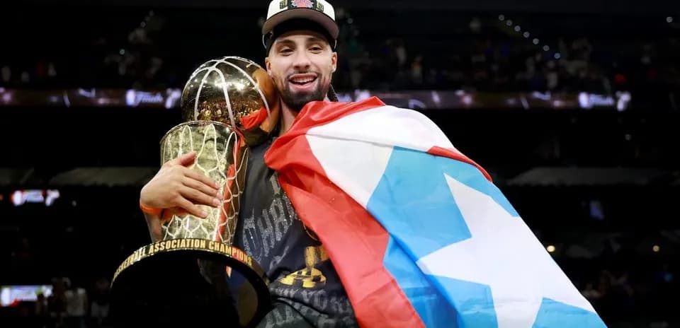 Player celebrating with trophy and flag after championship