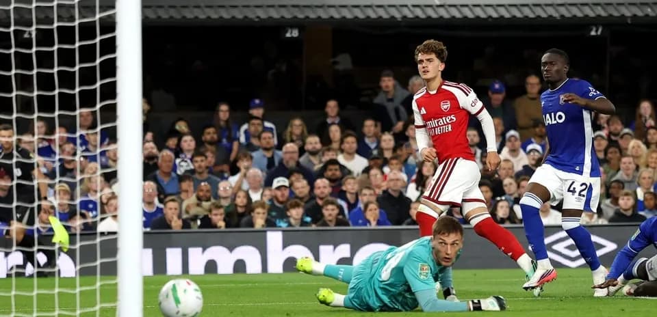 Goalkeeper diving as player scores for Arsenal