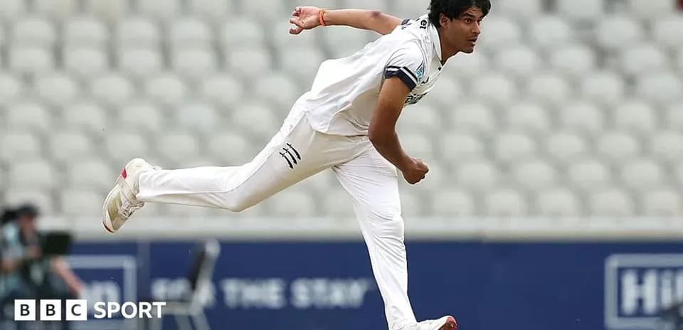 Cricketer bowling during a match at the stadium