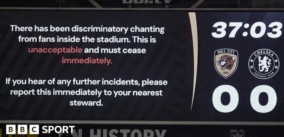 Scoreboard displaying discriminatory chanting announcement during match