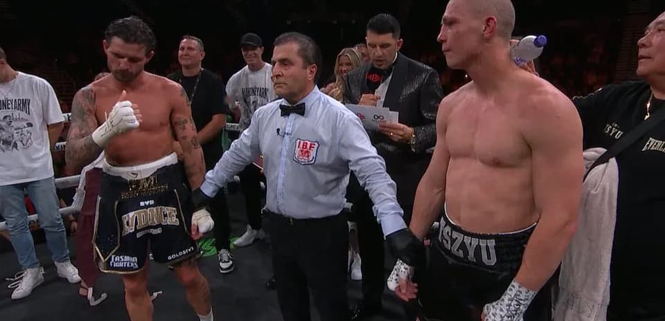 Boxers and referee in the ring after match