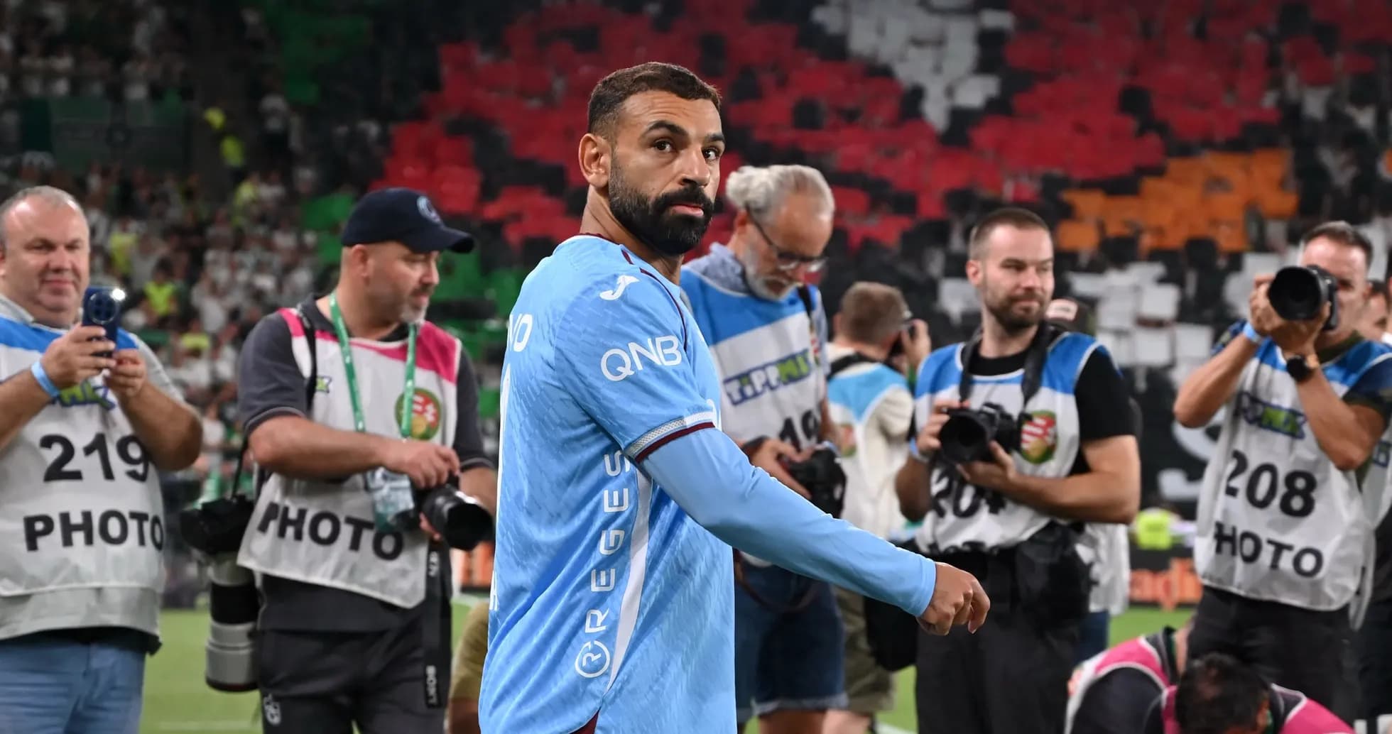 Player walking past photographers after the match