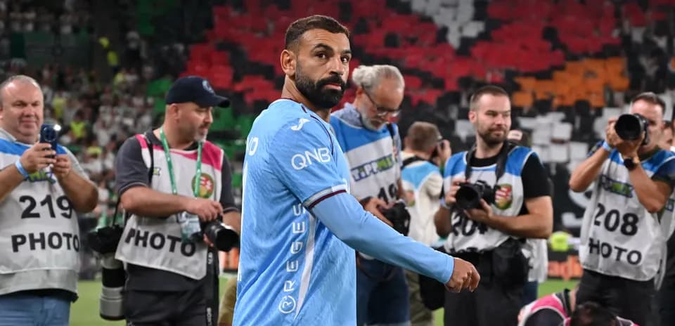 Player walking past photographers after the match
