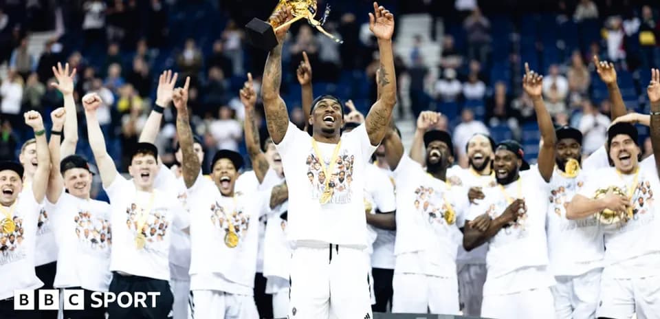 Team celebrating with trophy after winning championship