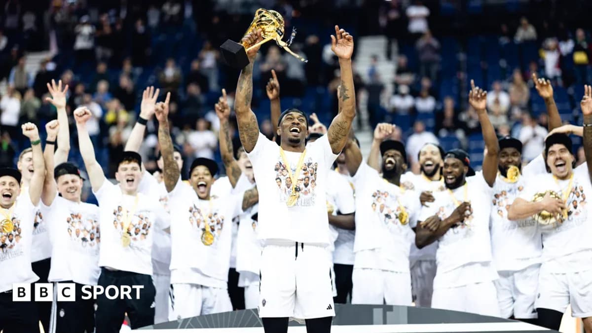 Team celebrating with trophy after winning championship