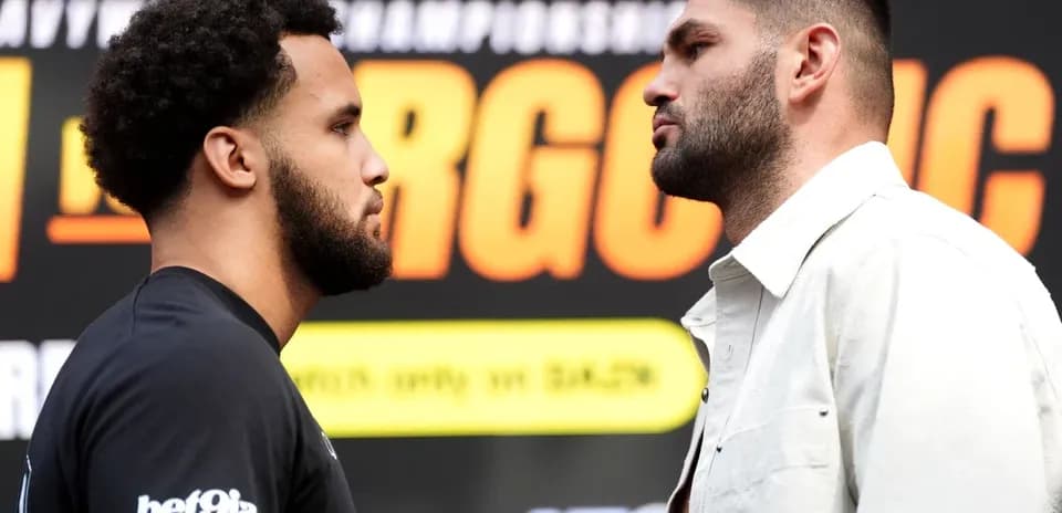 Two boxers facing off at a promotional event
