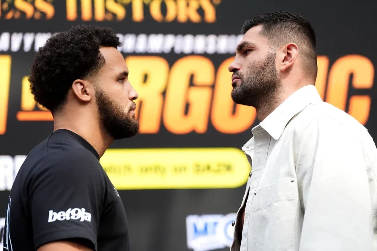 Two boxers facing off at a promotional event