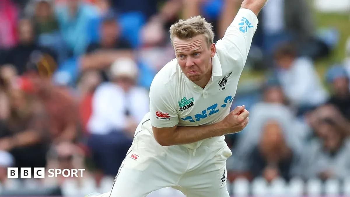Cricketer bowling during a match in white kit