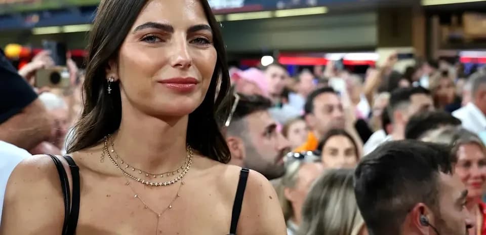 Woman smiling in a crowded stadium audience