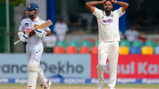 Batsman playing defensively, bowler reacting in frustration