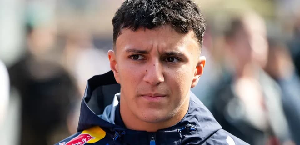 Driver wearing team jacket in paddock area